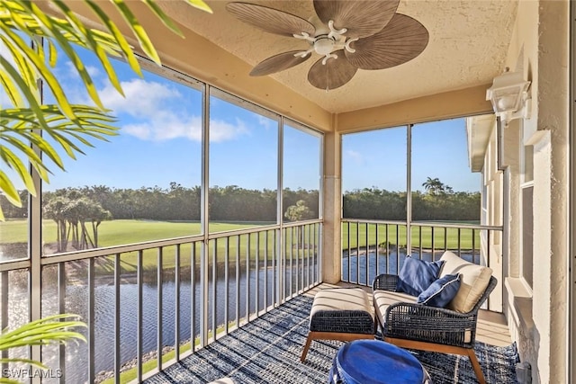 3570 Haldeman Creek Dr Unit 134, Naples, FL 34112 - sunroom with ceiling fan, a wealth of natural light, view of golf course, and a water view