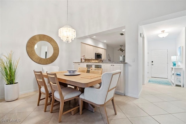 3570 Haldeman Creek Dr Unit 134, Naples, FL 34112 - dining space with light tile patterned floors, baseboards, a notable chandelier, and a high ceiling