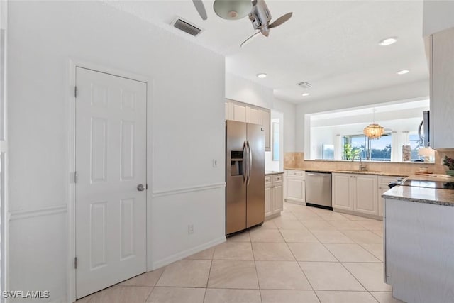 3570 Haldeman Creek Dr Unit 134, Naples, FL 34112 - kitchen with visible vents, a sink, ceiling fan, stainless steel appliances, and decorative backsplash