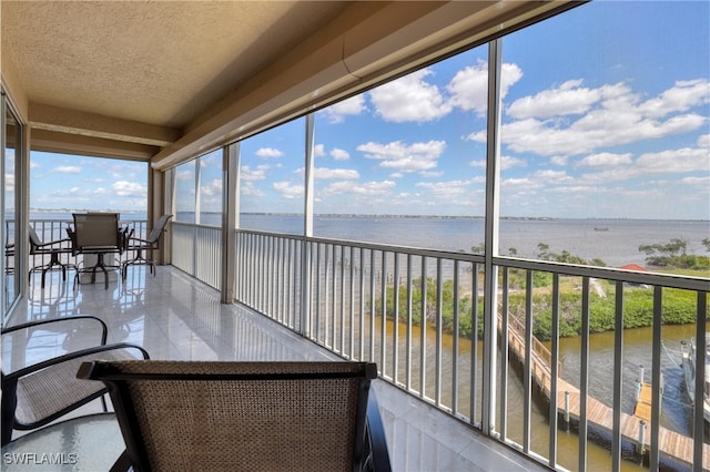 15220 Portside Dr Unit 301, Fort Myers, FL 33908 - sunroom / solarium with tile patterned flooring, a textured ceiling, and a water view