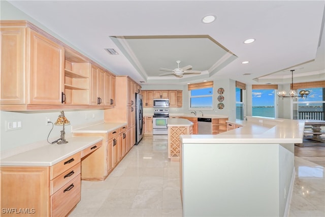 15220 Portside Dr Unit 301, Fort Myers, FL 33908 - kitchen featuring stainless steel appliances, light brown cabinets, a raised ceiling, and a spacious island