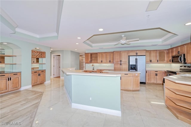 15220 Portside Dr Unit 301, Fort Myers, FL 33908 - kitchen featuring stainless steel appliances, a tray ceiling, light countertops, ornamental molding, and ceiling fan