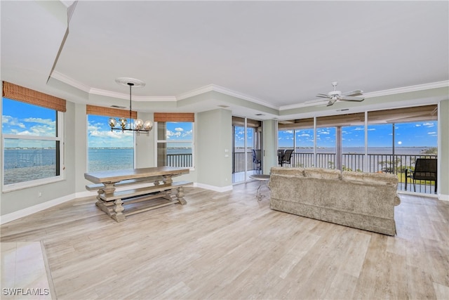 15220 Portside Dr Unit 301, Fort Myers, FL 33908 - living area with a raised ceiling, wood finished floors, crown molding, and baseboards