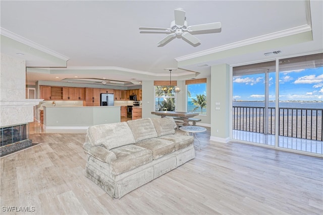 15220 Portside Dr Unit 301, Fort Myers, FL 33908 - living area with light wood-style flooring, a tray ceiling, visible vents, ceiling fan with notable chandelier, and ornamental molding