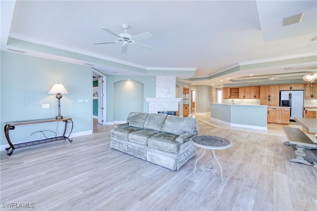 15220 Portside Dr Unit 301, Fort Myers, FL 33908 - living room featuring a tray ceiling, light wood-style floors, and ornamental molding