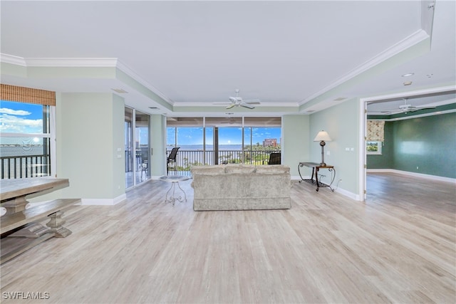 15220 Portside Dr Unit 301, Fort Myers, FL 33908 - unfurnished living room featuring a ceiling fan, ornamental molding, and a raised ceiling