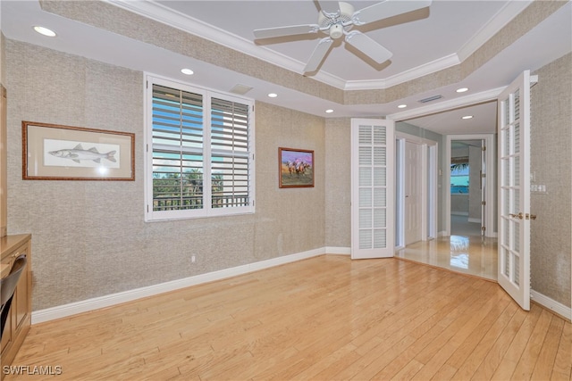 15220 Portside Dr Unit 301, Fort Myers, FL 33908 - empty room with wallpapered walls, visible vents, french doors, crown molding, and hardwood / wood-style flooring