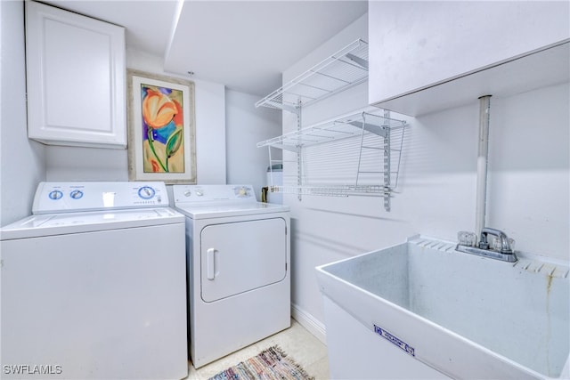 15220 Portside Dr Unit 301, Fort Myers, FL 33908 - washroom featuring washing machine and clothes dryer, a sink, light tile patterned floors, and cabinet space