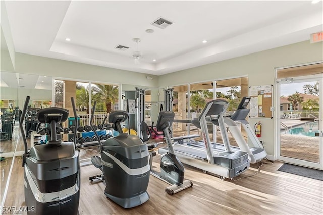 15220 Portside Dr Unit 301, Fort Myers, FL 33908 - workout area with plenty of natural light, wood finished floors, visible vents, and a tray ceiling
