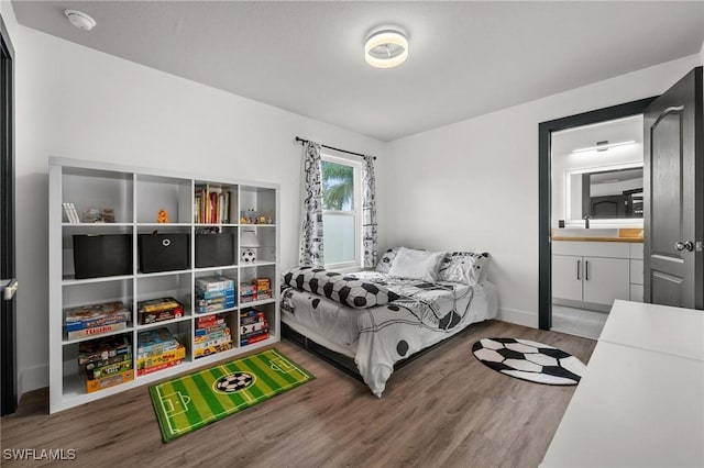 2513 Blackburn Cir, Cape Coral, FL 33991 - bedroom with wood finished floors, ensuite bathroom, and baseboards
