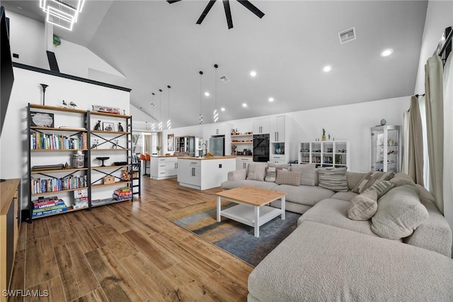 2513 Blackburn Cir, Cape Coral, FL 33991 - living room with wood finished floors, recessed lighting, ceiling fan, high vaulted ceiling, and a chandelier