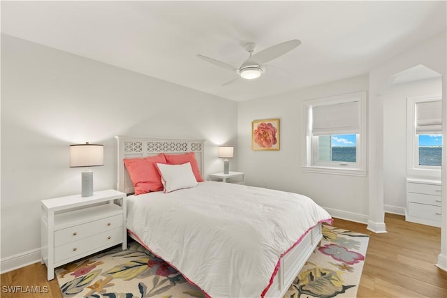 8451 Casa Del Rio Ln, Fort Myers, FL 33919 - bedroom with light wood-style flooring, a ceiling fan, and baseboards