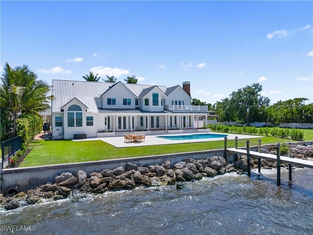 8451 Casa Del Rio Ln, Fort Myers, FL 33919 - back of house featuring a lawn, a fenced backyard, a patio, a balcony, and an outdoor pool