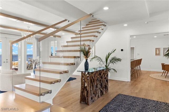 8451 Casa Del Rio Ln, Fort Myers, FL 33919 - staircase featuring recessed lighting, wood finished floors, and a healthy amount of sunlight