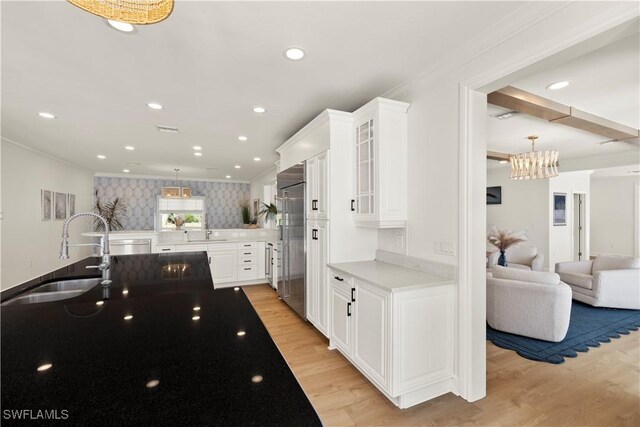 8451 Casa Del Rio Ln, Fort Myers, FL 33919 - kitchen featuring white cabinetry, crown molding, stainless steel built in fridge, a sink, and light wood finished floors
