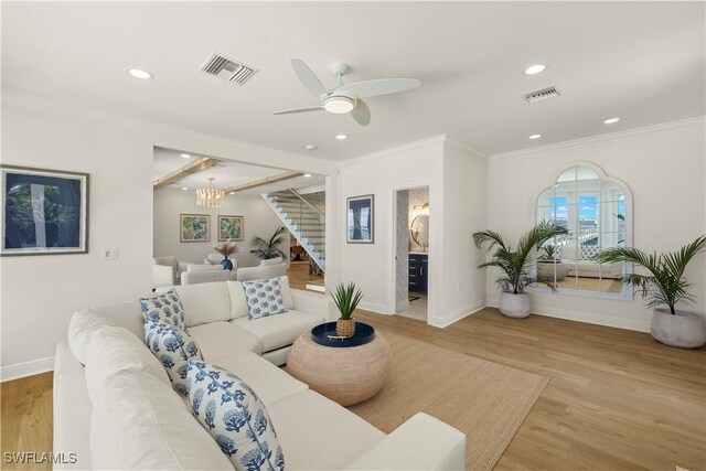 8451 Casa Del Rio Ln, Fort Myers, FL 33919 - living area featuring crown molding, baseboards, visible vents, and stairs