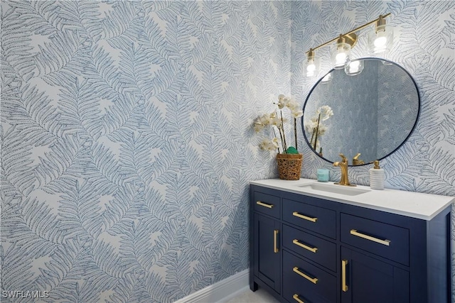 8451 Casa Del Rio Ln, Fort Myers, FL 33919 - bathroom with wallpapered walls, vanity, and baseboards