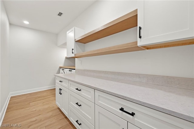 8451 Casa Del Rio Ln, Fort Myers, FL 33919 - interior space with light wood-style floors, open shelves, white cabinets, recessed lighting, and baseboards