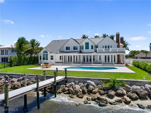 8451 Casa Del Rio Ln, Fort Myers, FL 33919 - back of house featuring french doors, a patio area, metal roof, and a balcony