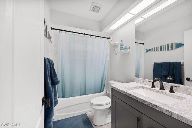 bathroom with shower / tub combo with curtain, visible vents, vanity, and toilet