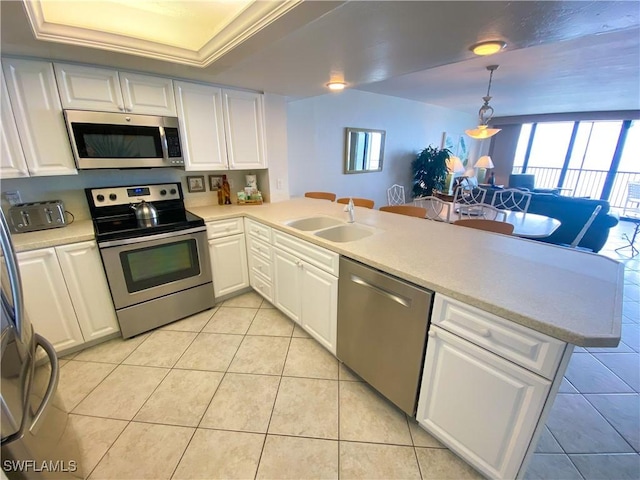 kitchen with light tile patterned flooring, plenty of natural light, stainless steel appliances, and a sink