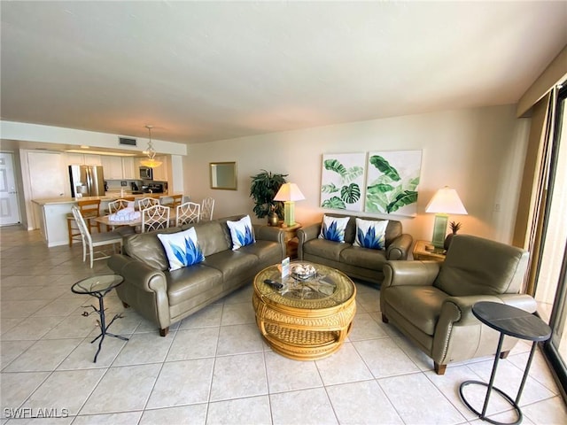 living area featuring visible vents and light tile patterned floors