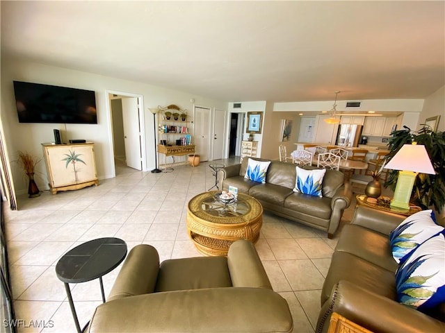 living area featuring visible vents and light tile patterned floors