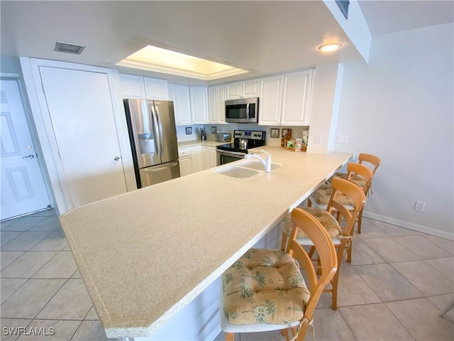 kitchen featuring light tile patterned flooring, light countertops, visible vents, and stainless steel appliances