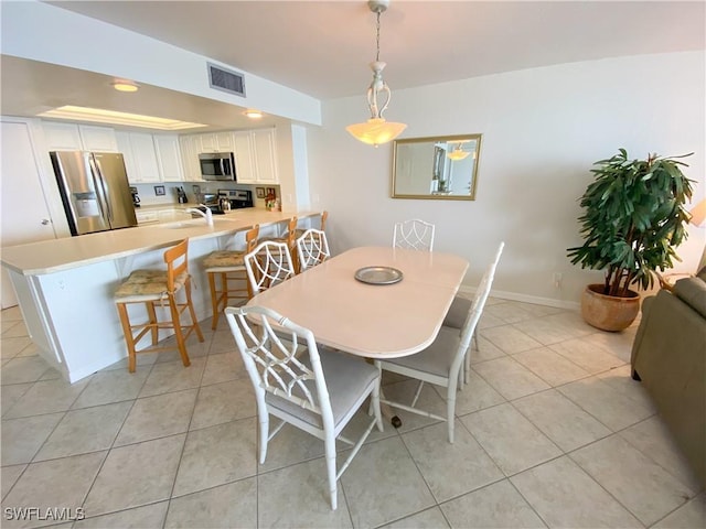 dining area featuring visible vents, baseboards, and light tile patterned floors