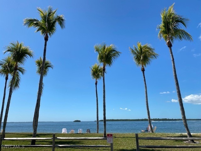 property view of water featuring fence