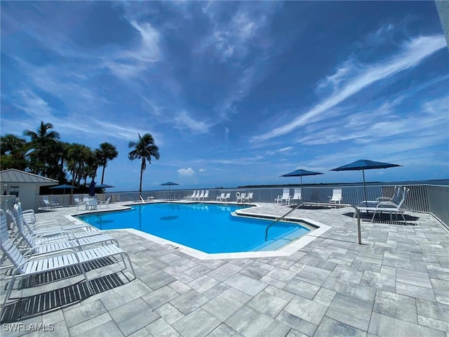 pool featuring fence and a patio