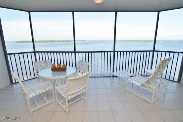 sunroom / solarium with a wealth of natural light and a water view