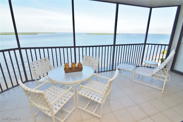 sunroom / solarium featuring plenty of natural light and a water view