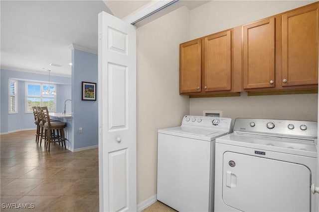 9719 Acqua Ct Unit 241, Naples, FL 34113 - washroom with cabinet space, washer and dryer, baseboards, and light tile patterned floors