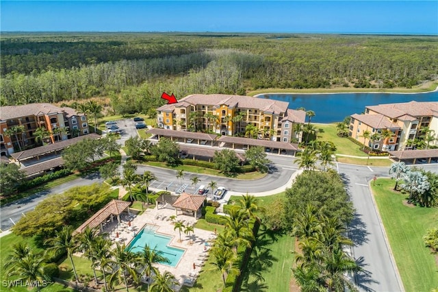 9719 Acqua Ct Unit 241, Naples, FL 34113 - bird's eye view of a forest, a nearby body of water, and a pool area