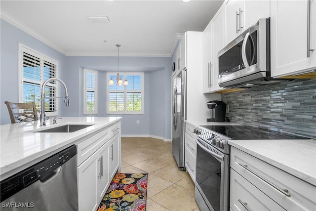 9719 Acqua Ct Unit 241, Naples, FL 34113 - kitchen featuring stainless steel appliances, a sink, crown molding, tasteful backsplash, and white cabinetry