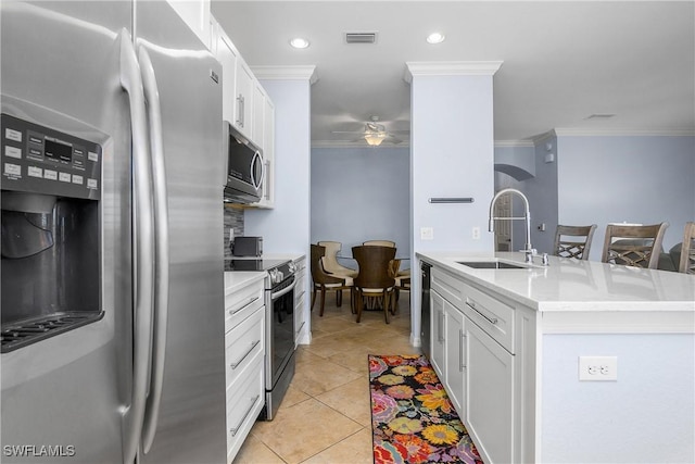 9719 Acqua Ct Unit 241, Naples, FL 34113 - kitchen featuring appliances with stainless steel finishes, a sink, ornamental molding, ceiling fan, and light countertops