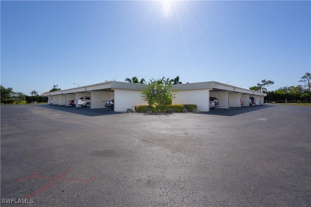 6102 Augusta Dr Unit 315, Fort Myers, FL 33907 - view of front of house with stucco siding and covered parking