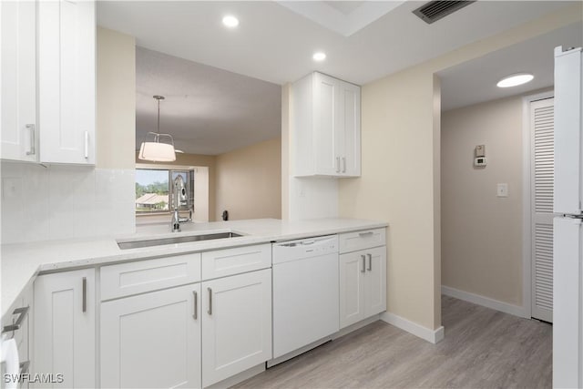 6102 Augusta Dr Unit 315, Fort Myers, FL 33907 - kitchen featuring light wood-style flooring, white dishwasher, white cabinets, a sink, and visible vents