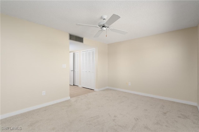 6102 Augusta Dr Unit 315, Fort Myers, FL 33907 - spare room with a textured ceiling, light colored carpet, visible vents, ceiling fan, and baseboards