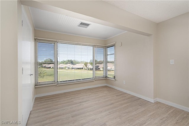 6102 Augusta Dr Unit 315, Fort Myers, FL 33907 - empty room with baseboards, visible vents, wood finished floors, and crown molding