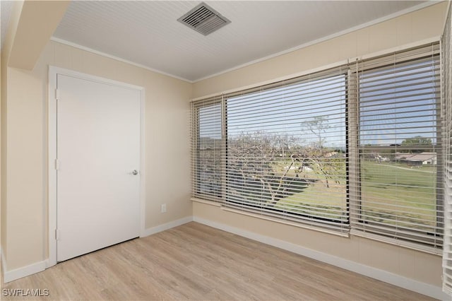 6102 Augusta Dr Unit 315, Fort Myers, FL 33907 - unfurnished room with ornamental molding, visible vents, wood finished floors, and baseboards