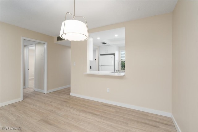 6102 Augusta Dr Unit 315, Fort Myers, FL 33907 - spare room featuring visible vents, light wood-style flooring, and baseboards
