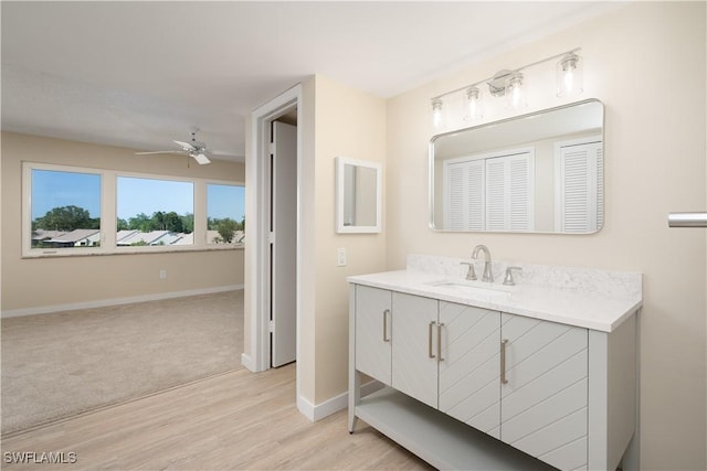 6102 Augusta Dr Unit 315, Fort Myers, FL 33907 - bathroom featuring vanity, a ceiling fan, wood finished floors, and baseboards