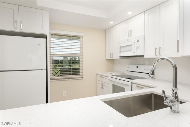 6102 Augusta Dr Unit 315, Fort Myers, FL 33907 - kitchen featuring recessed lighting, a sink, white cabinetry, and white appliances