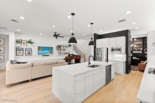 4045 Nova Ln, Naples, FL 34119 - kitchen with a sink, visible vents, light wood-style floors, and stainless steel appliances