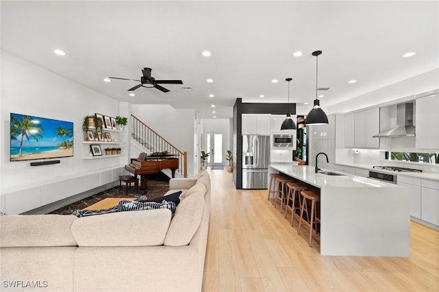 4045 Nova Ln, Naples, FL 34119 - living area with light wood-type flooring, stairs, a ceiling fan, and recessed lighting