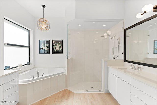 4045 Nova Ln, Naples, FL 34119 - full bath with a bath, tiled shower, vanity, recessed lighting, and wood finished floors