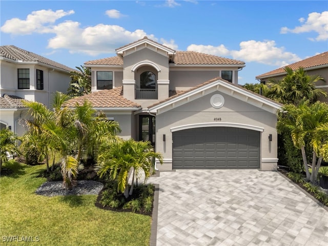4045 Nova Ln, Naples, FL 34119 - mediterranean / spanish-style home featuring a front yard, stucco siding, decorative driveway, and a tile roof