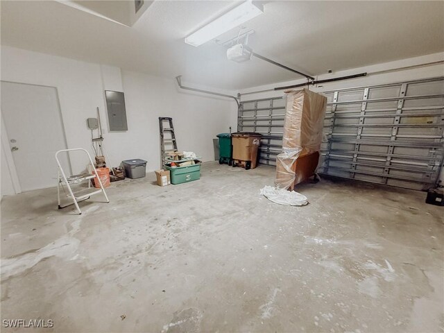 garage with electric panel and a garage door opener